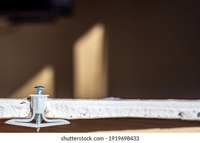 Side View Of A Drywall Mount Anchor And Screw For Hanging Objects On Walls