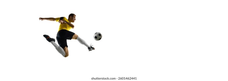 Side view dynamic image of man, soccer player training, playing, kicking ball mid-air isolated on white background. Concept of sport, competition, game, active lifestyle. Copy space for ad, text