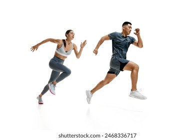 Side view dynamic photo of woman and man in mid-run, demonstrating their athletic prowess against white studio background. Concept of people in sport, healthy lifestyle, teamwork, motivation. Ad