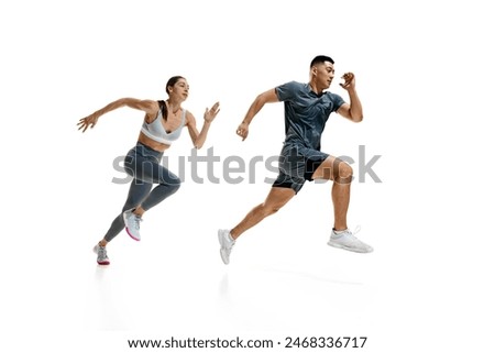 Image, Stock Photo Side view of two friends stand in a gaming area fully immersed in a virtual reality world wearing VR headsets and holding motion controllers in neon light room