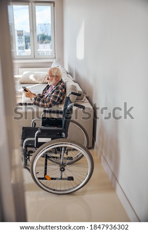 Similar – Caregiver with elderly patient in a wheelchair in front of window