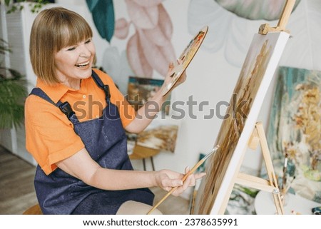 Similar – Image, Stock Photo Elderly woman artist holding a paintbrush in a studio