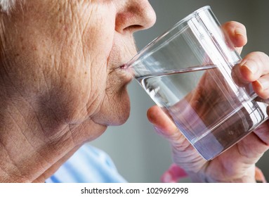 Side View Of Elderly Woman Drinking Water