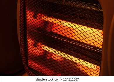 Side View Electric Heater Working In Dark Space