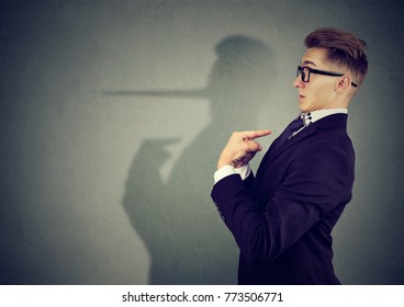 Side view of elegant man looking surprised when being caught on lie.  - Shutterstock ID 773506771