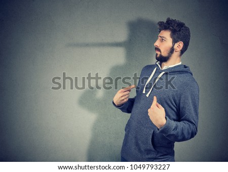 Side view of elegant man looking surprised when being caught on lie. 