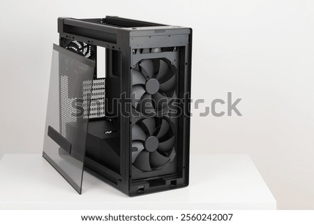 Side view of empty  big tower, PC case, chassis, removable tempered-glass left panel, two extra-thick 200 x 38 mm front fans for maximum air intake