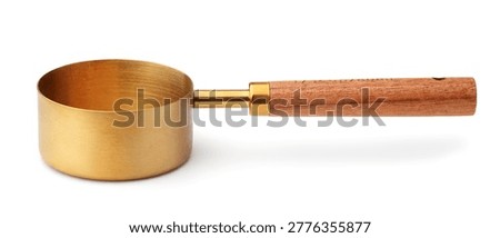 Side view of empty brass measuring cup with wooden handle isolated on white