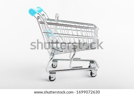 Side view of empty shooping cart or troley isolated on white
