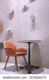 Side view of empty table set beside gray tile wall decoration in minimal style and vertical frame