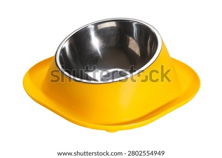 Side view of empty yellow water moat anti ant small dog and cat food bowl isolated on white background with clipping path.