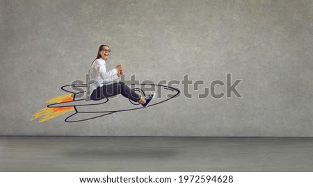 Side view of excited smiling laughing woman flying in air riding hand drawn cartoon doodle rocket with burning blast off flame. Using creative power, reaching success, achieving business goal concept