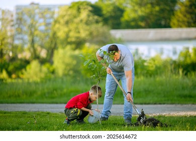 side view father and son planting tree with shovel and bucket of water at front of house, nice sunny day, father and son work together, Planting a family tree. Spring concept, nature and care - Powered by Shutterstock