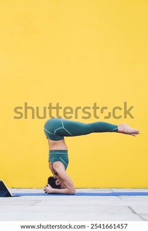 Woman doing a handstand on the beach