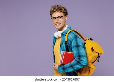 Side View Fun Young Boy Teen Student Wear Casual Clothes Backpack Headphones Glasses Hold Many Book Isolated On Plain Light Violet Background Studio Education In High School University College Concept