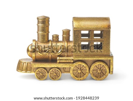 Side view of golden toy steam train locomotive isolated on white