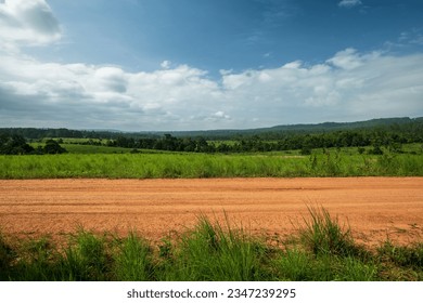 Side view of gravel road in countryside with meadow. - Powered by Shutterstock