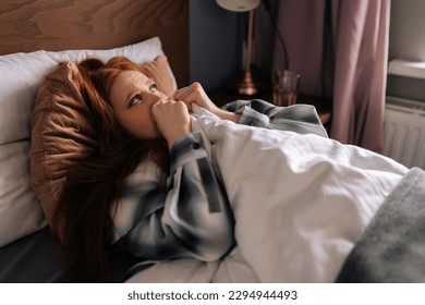 Side view of grief-stricken woman crying lying alone on bed under blanket, have depression and stress, looking hopelessly away. Sad female suffering from emotional disorders, psychological problems. - Shutterstock ID 2294944493