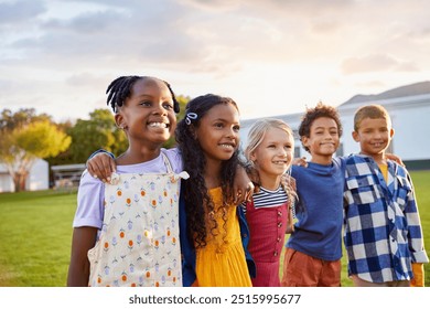 Side view of group of friends standing and hugging while looking away. Small schoolchildren enjoying summer break in outside park. Group of diverse little boys and cute girls with arms around smiling. - Powered by Shutterstock