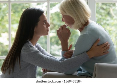 Side View Grown Up Adult Daughter Soothe 60s Elderly Mother Showing Empathy Give Her Moral Support While She Crying Wipe Tears With Tissue, Health Problem Serious Disease, Divorce Broken Heart Adult