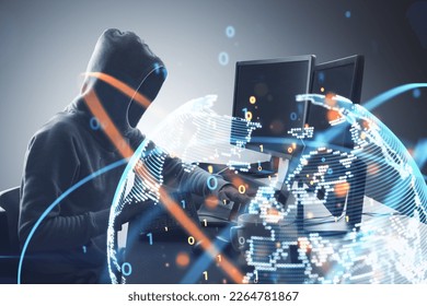 Side view of hacker at desktop using computers with glowing globe hologram. Global hacking, crime and phishing concept. Double exposure