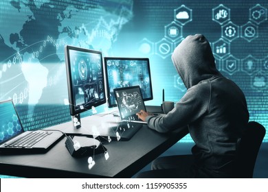 Side view of hacker using computer with digital interface while sitting at desk of blurry interior. Hacking and phishing concept.