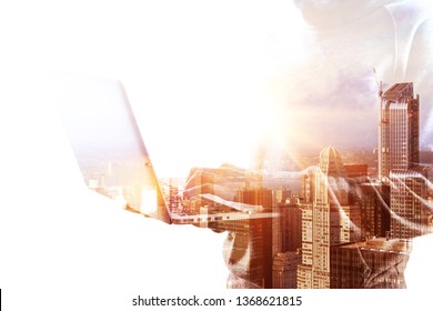 Side view of hacker using laptop on bright white city background. Technology and theft concept. Double exposure 