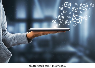Side view of hand holding touchpad with drawn email icons on white background. E-mail marketing concept  - Powered by Shutterstock