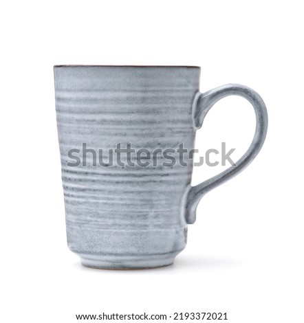 Side view of handmade rough ceramic coffee mug isolated on white