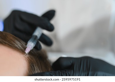Side view of handsome man getting hair treatment at beauty salon. Man having mesotherapy session at aesthetic clinic, therapist hands in gloves making injection in scalp, closeup