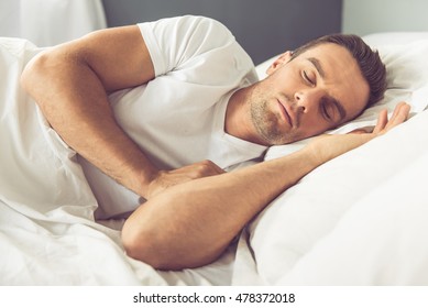 Side View Of Handsome Man Sleeping In His Bed At Home