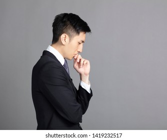 Side View Of Handsome Young Business Man Thinking