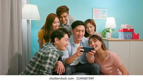 Side View Of Happy Asian Friends Smile Watch Man Using Phone Playing Game - Horizontal Landscape Mobile