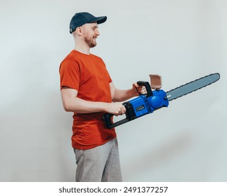 Side view of a happy carpenter holding chainsaw, power tools, DIY, forestry work, outdoor activity, equipment, manual labor - Powered by Shutterstock