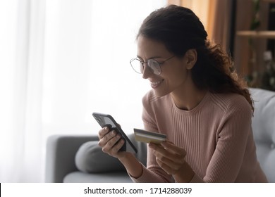 Side View Happy Female Client Holding Plastic Credit Card In Hands, Ordering Food, Taxi Or Plane Tickets In Mobile Application, Satisfied With User Friendly Interface, Easy Technology E-banking Usage.