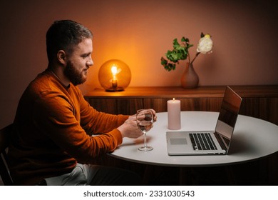 Side view of happy young man making video call using laptop computer presenting ring and making remote marriage proposal. Loving boyfriend making distant proposal for marriage, marry me. - Powered by Shutterstock