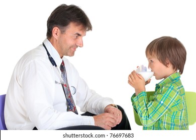 Side View Of Healthy Young Boy Drinking Glass Of Milk With Smiling Doctor, Isolated On White Background.