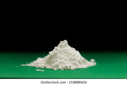 Side view of heap of white modified starch isolated on green background