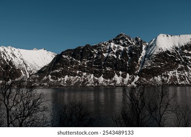 Side view of a high mountain range on the seashore