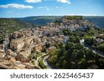 Side view of the historic center of Ibla in Ragusa, Sicily, Italy, with its houses cascading over a hill, a UNESCO World Heritage Site.