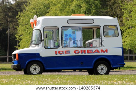 Side view of ice cream van in green countryside