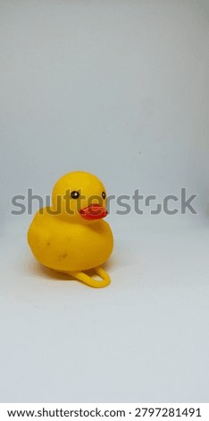 Side view of an iconic yellow rubber ducky toy on a plain white studio background, perfect for commercial use