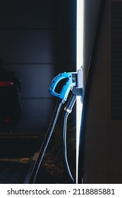 Side View Of Illuminated Electric Car Charger At Night