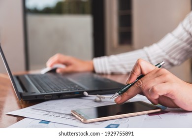 Side view image of a person's hands using a smart phone and working with their smartphone.