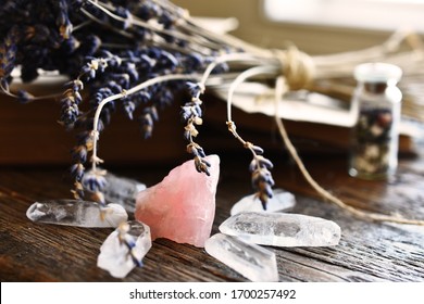 A Side View Image Of Rose Quartz And Clear Quartz Crystal With Dried Lavender And Old Book. 