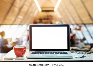 Side View Laptop And Coffee Cup On Desk Work In Coffee Shop
