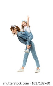 Side View Of Laughing Mother Piggybacking Daughter In Denim Outfit Isolated On White