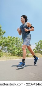  Side View Low Angle Of Asian Man Running On The Countryside