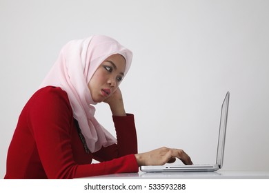 Side View Of The Malay Woman Using Laptop