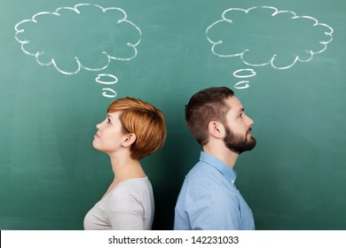 Side view of male and female professors with thought bubble on chalkboard - Powered by Shutterstock